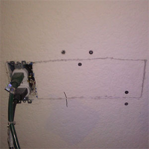 Patched drywall next to outlet
